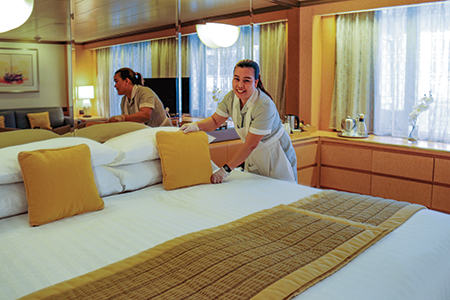 Cabin Stewardess making up bed in Suite