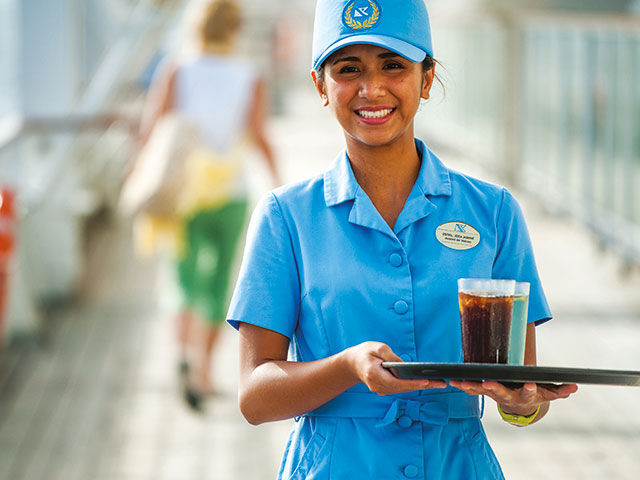 Bar Team member walking along the deck with tray of soft drinks
