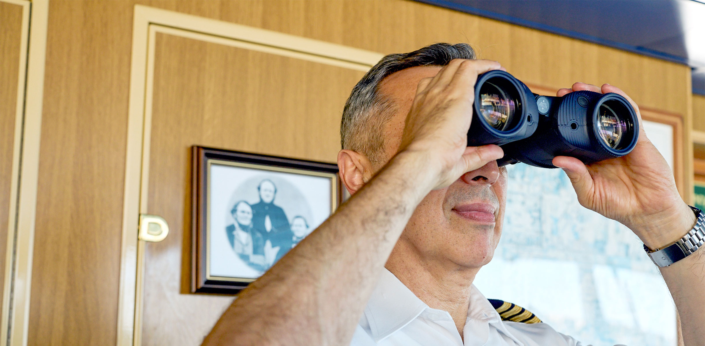 Captain looking through binoculars, Borealis