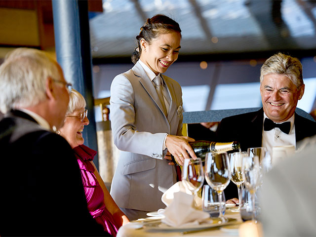 Guests dining in the Main Restaurant, Borealis, formal evening