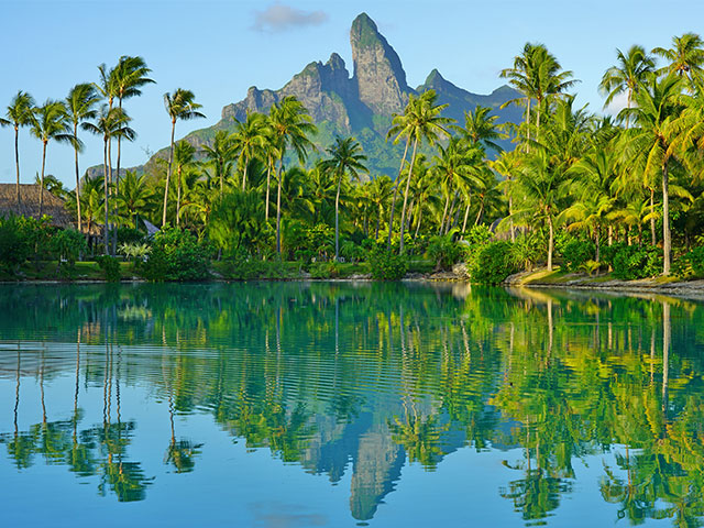 View of the Mont Otemanu mountain reflecting in water at sunset in Bora Bora, French Polynesia,