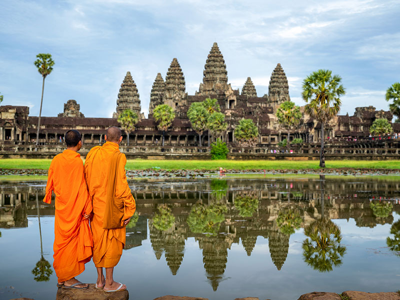 Asian monks looking at Angkor wat, Cambodia