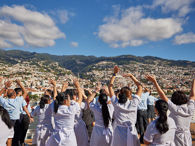 Crew waving at the Fleet in funchal