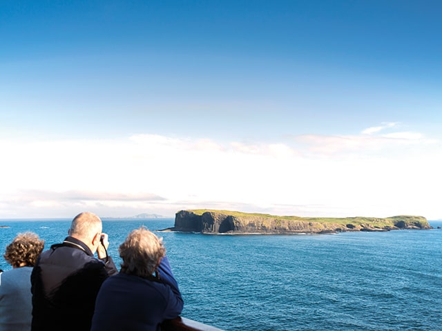Guests looking out to Fingal's cave, UK from deck
