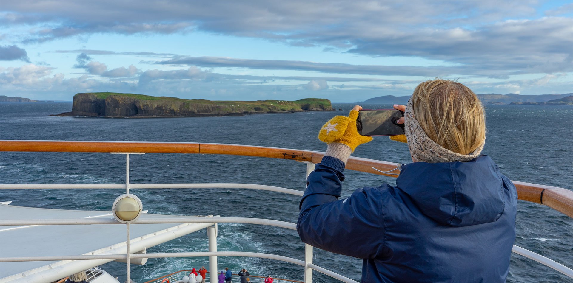Guest taking a picture of Fingal's cave from deck