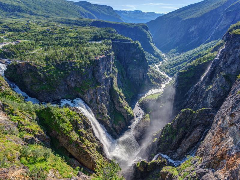 A majestic view of Vøringfossen, a powerful waterfall surrounded by rocky cliffs in Norway.