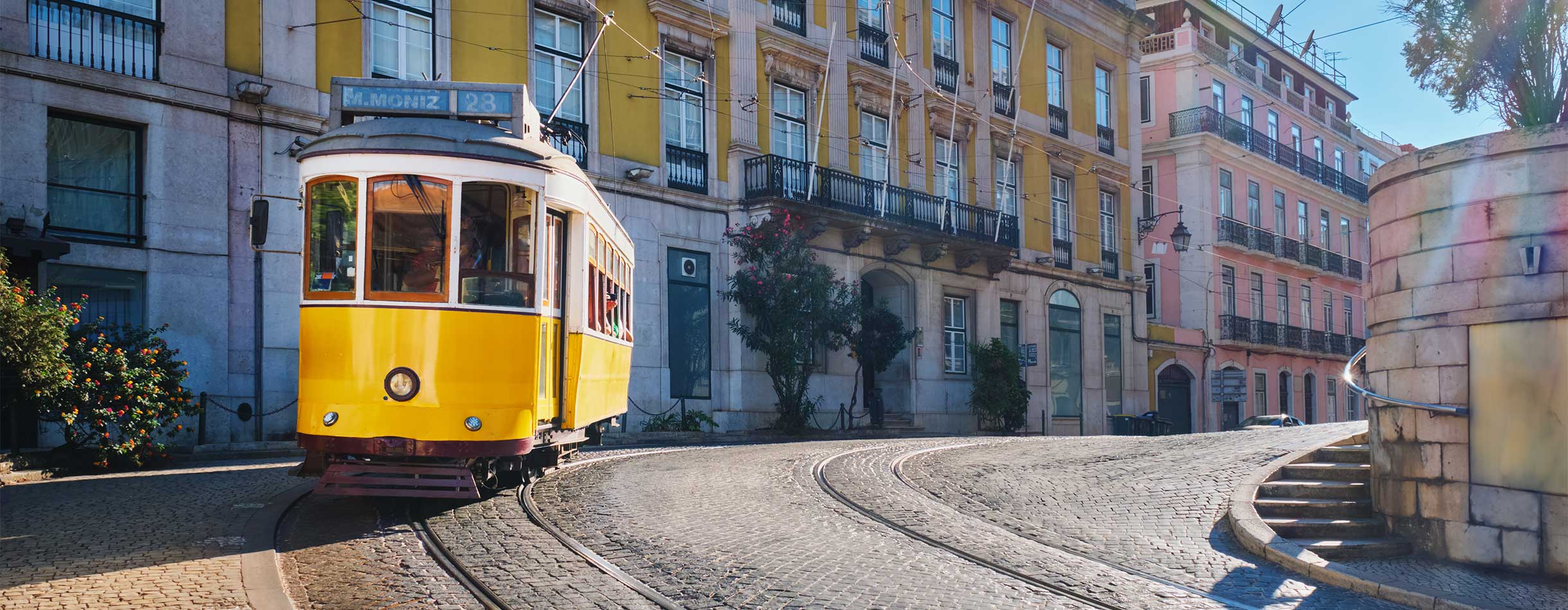 Portuguese yellow tram seen by visitors during a cruise to Lisbon, Portugal