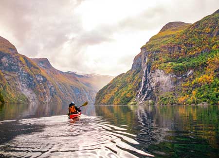 Guest kayaking during a cruise to Norway