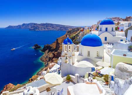 Beautiful blue roof and white washed buildings of Santorini. Cruise to Greece