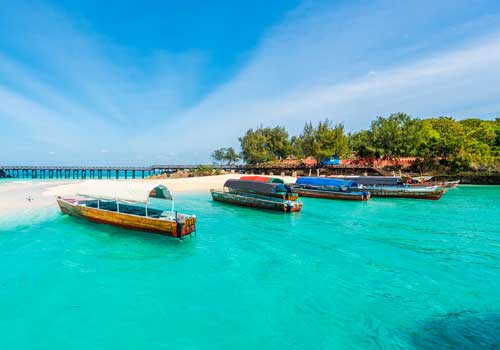Fishing boats in crystal blue water Zanzibar