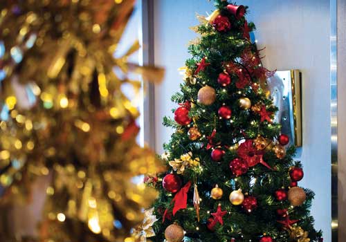 Christmas tree all decorated with red and gold decorations