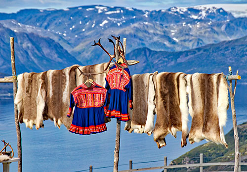 Sami clothing on washing line with reindeer skins
