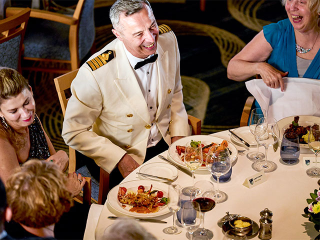 Captain with guests at dinner, formal night
