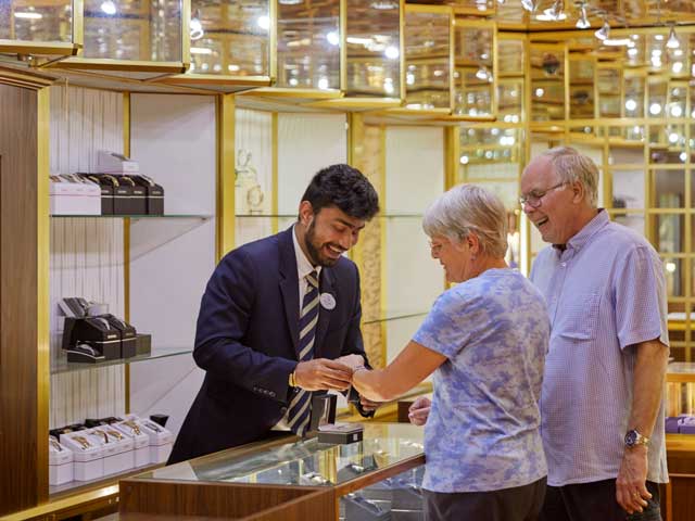 Guests picking out jewellery in boutique shop on board 