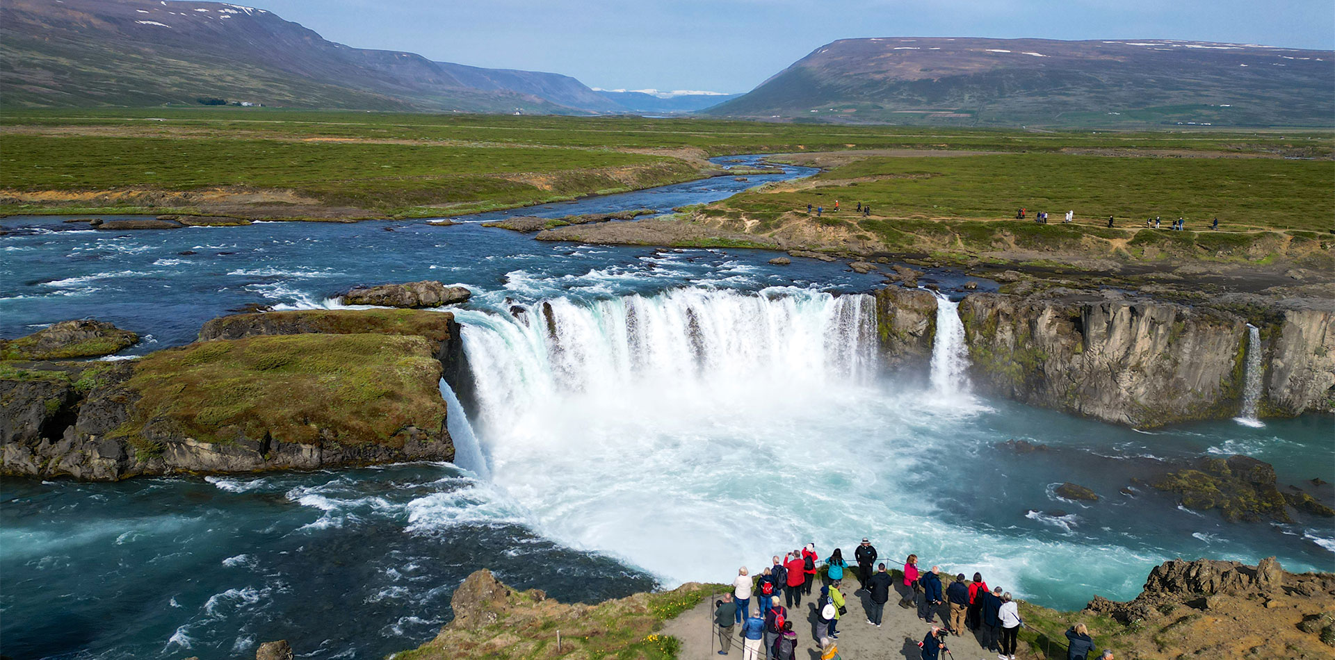 Guests visiting Godafoss waterfalls in Iceland