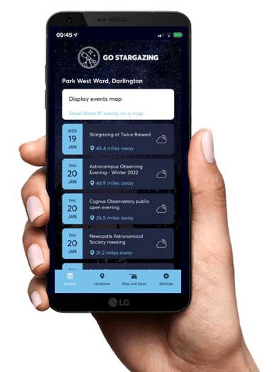 Hand holding a mobile phone displaying the Go Stargazing App