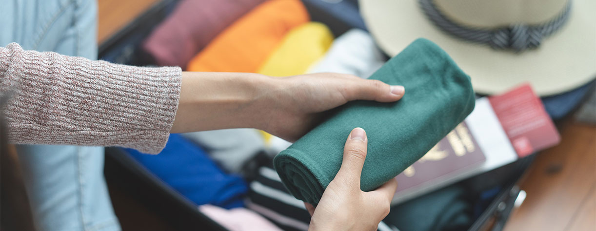 Rolling clothes to add to suitcase