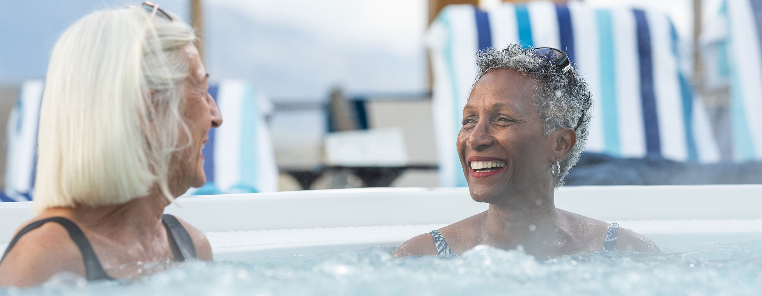 Solo travellers in jacuzzi, poolside, Bolette