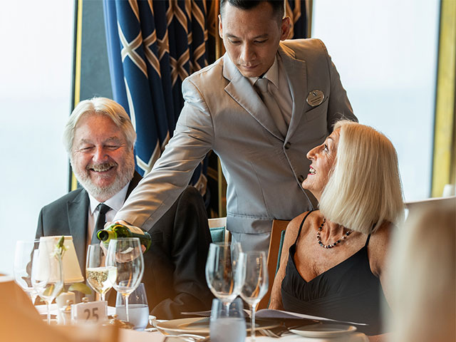 Guests being served by waiter in the main restaurant, formal night, Bolette