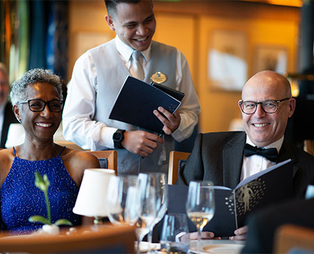 Guests in the main restaurant on formal evening with waiter