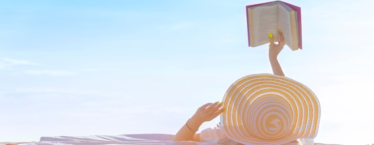 A lady reading a book on holiday