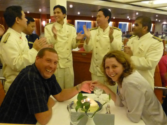 Mr and Mrs Edwards on a Fred. Olsen Cruise with waiters at dinner