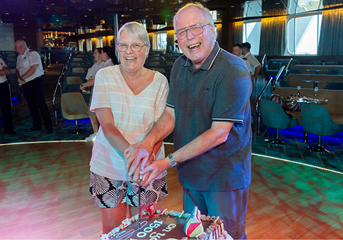 Mr and Mrs Stokes cutting their celebratory cake