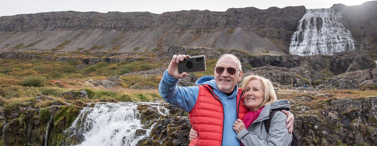 Couple taking selfie at Dyjandi waterfalls in Iceland