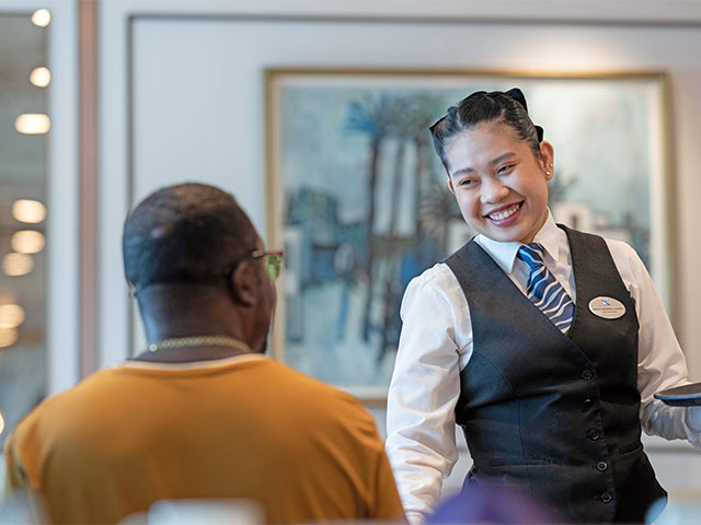 Waitress serving guest in Thistle restaurant, Balmoral