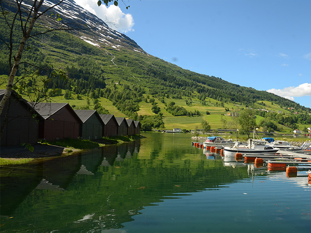 Beautiful views of wooden huts on the water in Olden, Norway