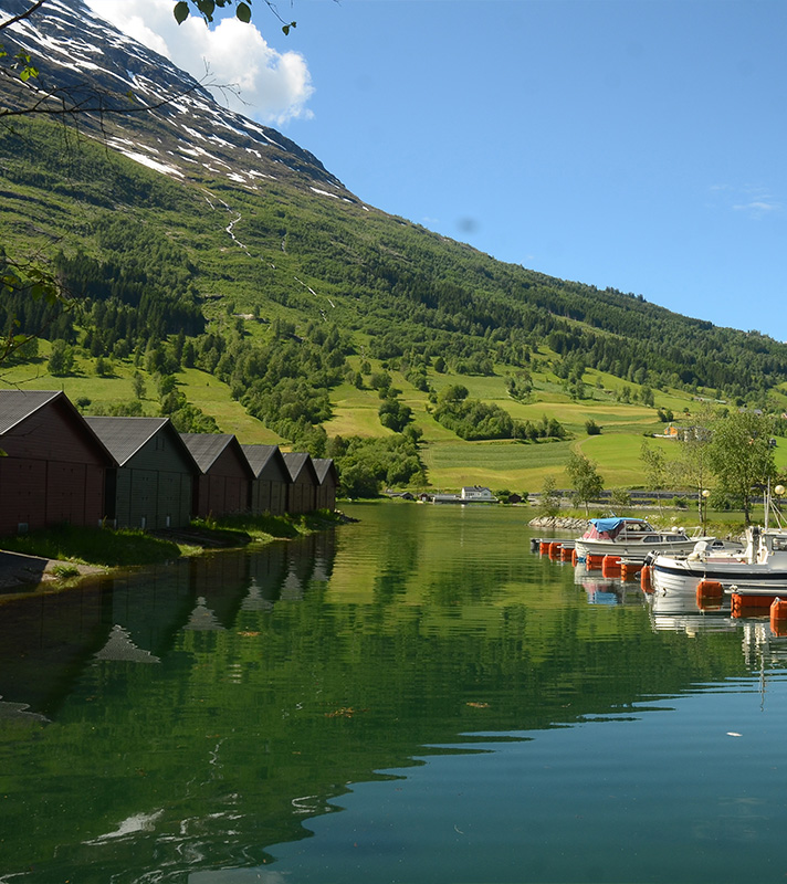 Beautiful views of wooden huts on the water in Olden, Norway
