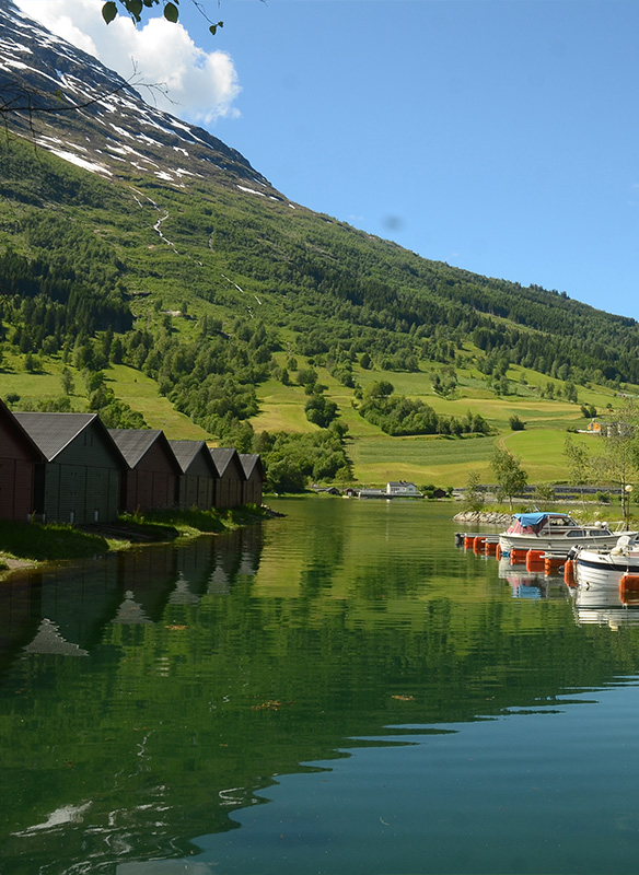 Beautiful views of wooden huts on the water in Olden, Norway