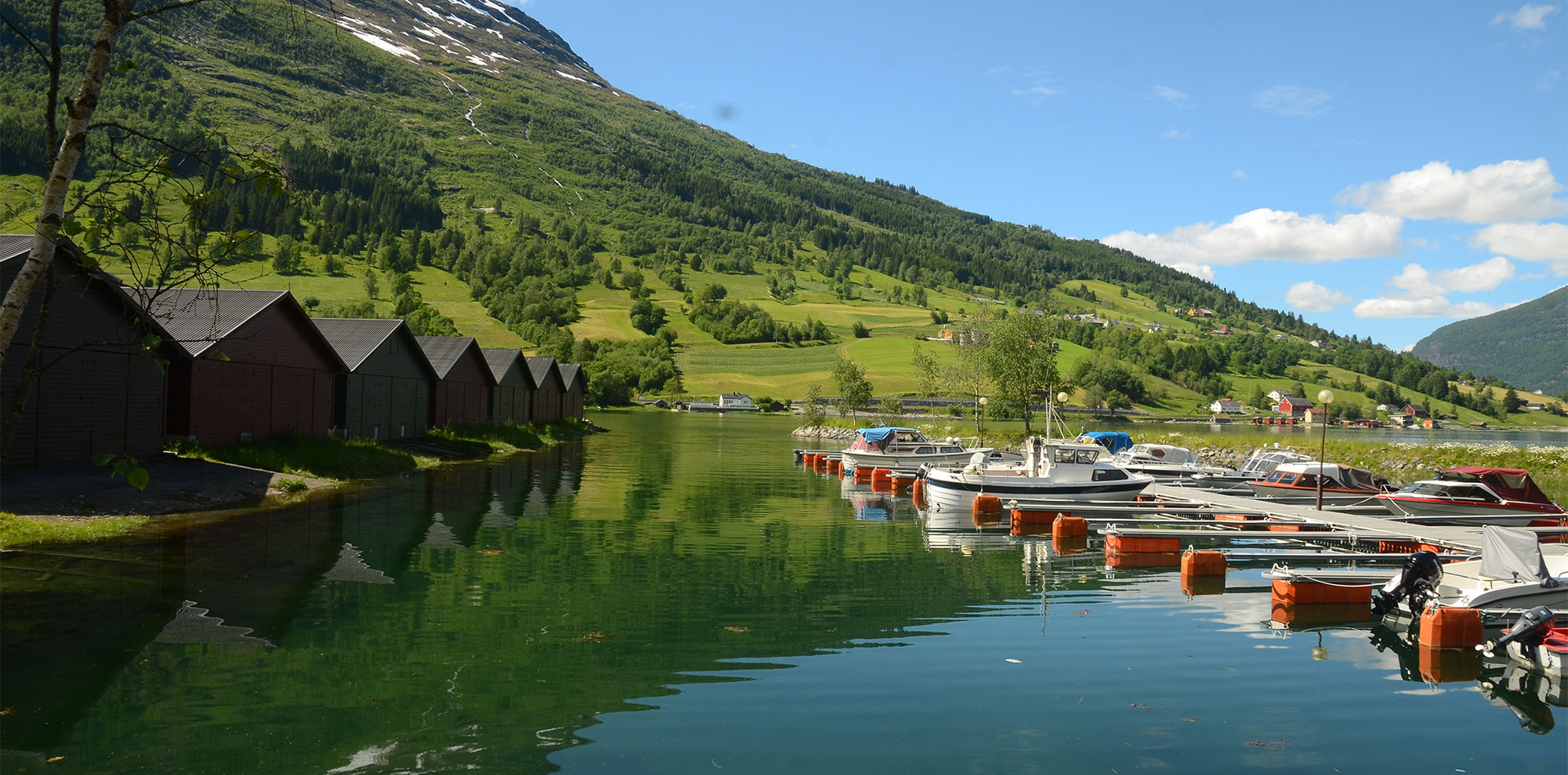 Beautiful views of wooden huts on the water in Olden, Norway