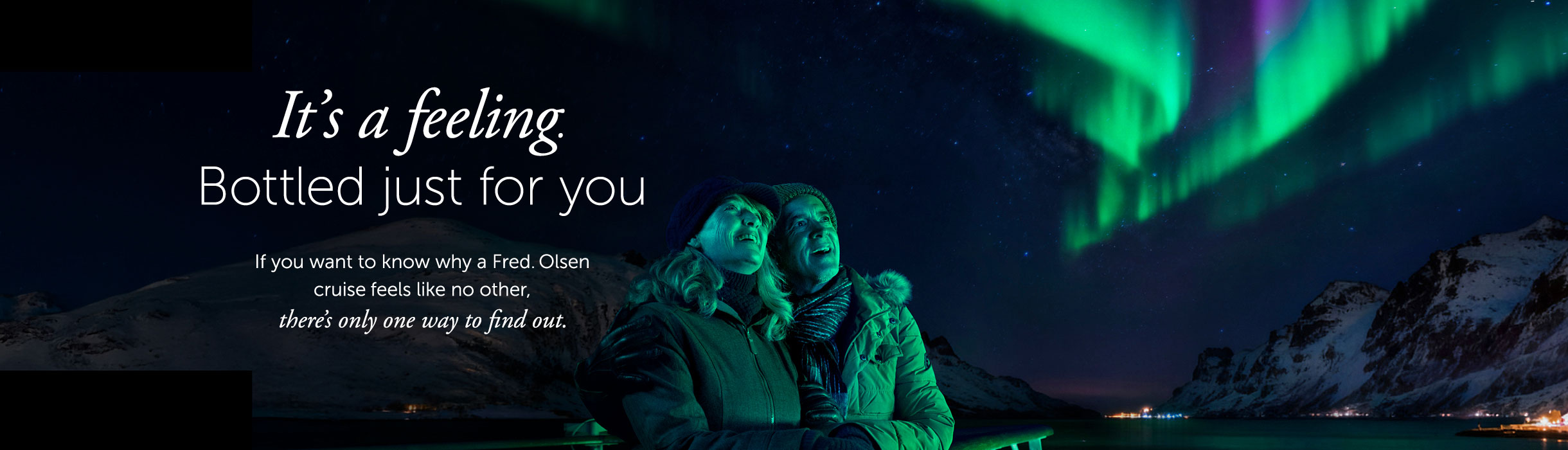 Guests looking up to Northern lights from deck