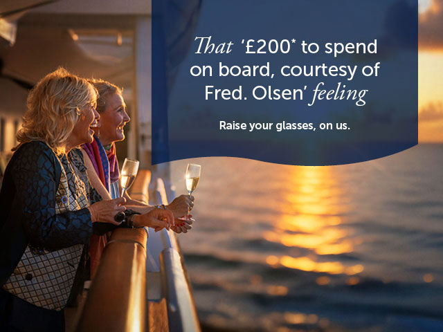 Guest looking out to sea from deck with drinks