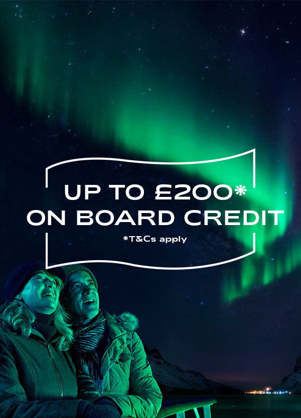 Guests looking up to Northern Lights from deck