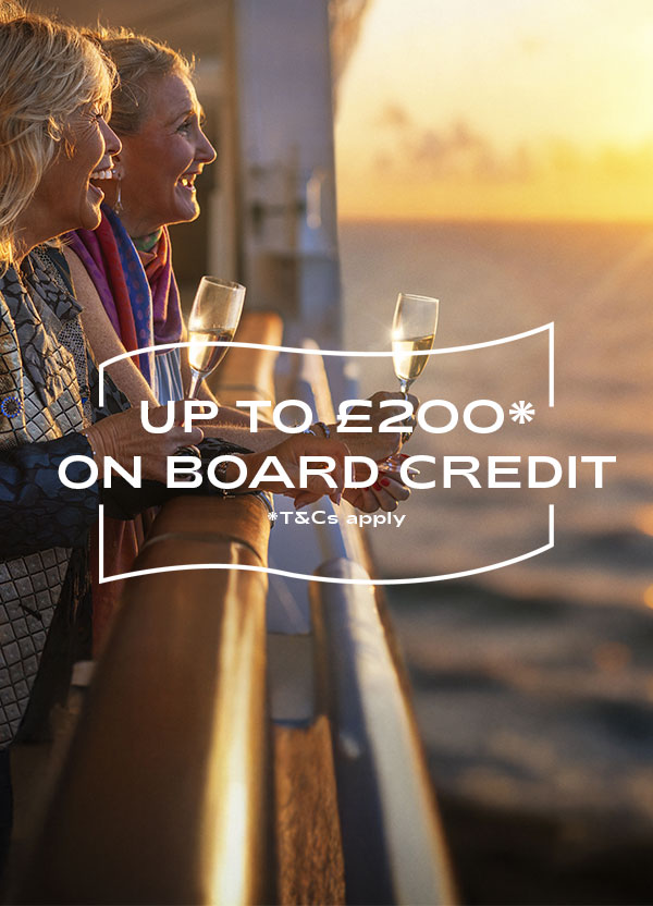 Guests looking out to sea from deck, with drinks