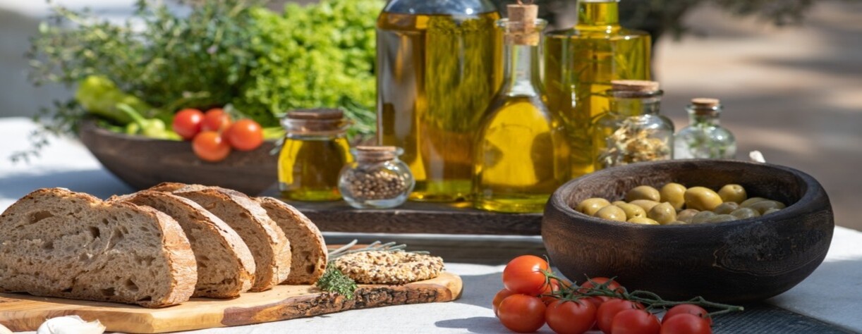Bread on a cutting board with olives and olive oil