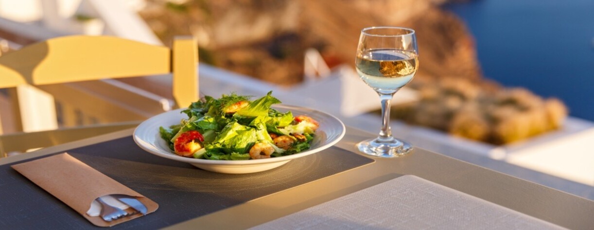Dinner with seafood and wine against the background of the sea