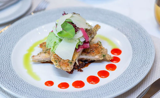 Monkfish with spinach and pancetta, courgetti strands and creamy saffron bisque