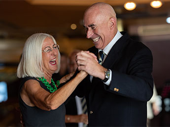 Solo travellers dancing with dance host on board