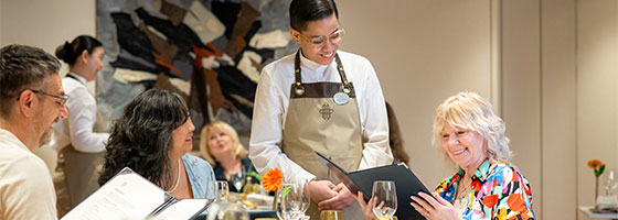 Waitress serving guests in the Colours and Tastes restaurant