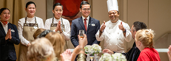Chef, Sommelier and restaurant staff at the Chef's table