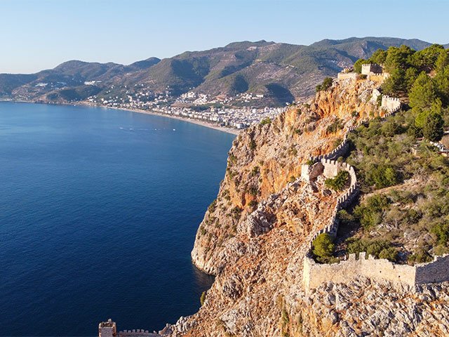 View of Historic Alanya Castle Walls with Kleopatra Beach in Alanya, Turkey