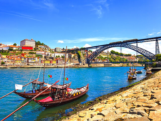 Oporto, Douro river, boats and iron bridge, Portugal