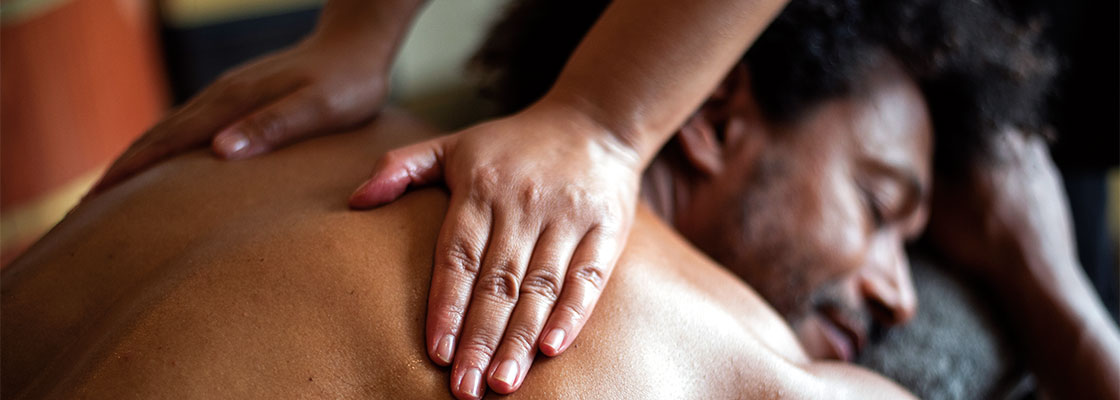 Guest receiving a back massage on board in the Atlantis spa