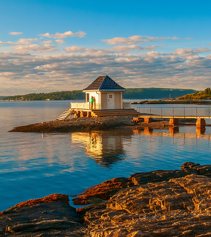 Scenery of Oslofjord with small fisher house on rocky island. Oslo, Norway.