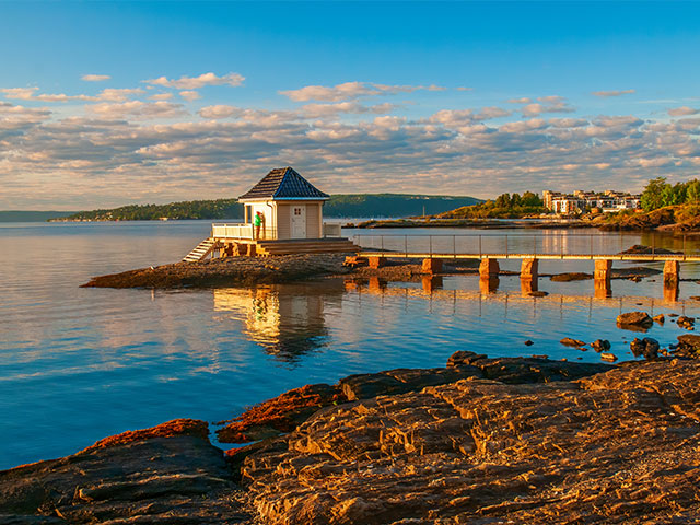 Scenery of Oslofjord with small fisher house on rocky island. Oslo, Norway.