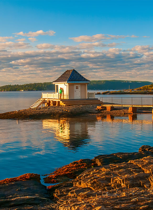 Scenery of Oslofjord with small fisher house on rocky island. Oslo, Norway.