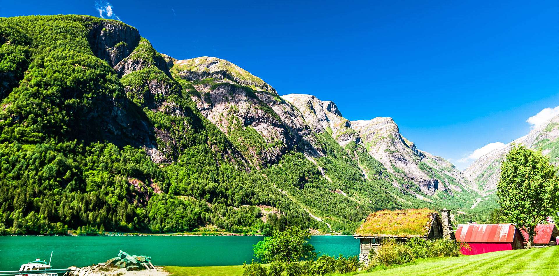 Typical wooden red buildings next to Sognefjord in Norway